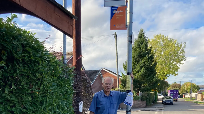 Cllr Ian Marks at a bus stop in Lymm